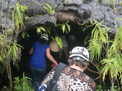 a group of people walking into a cave at Le Rubinjo - Appartement d'hôtes in Saint-Benoît