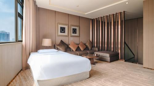 a hotel room with a bed and a couch at Crowne Plaza Kunming City Centre by IHG in Kunming