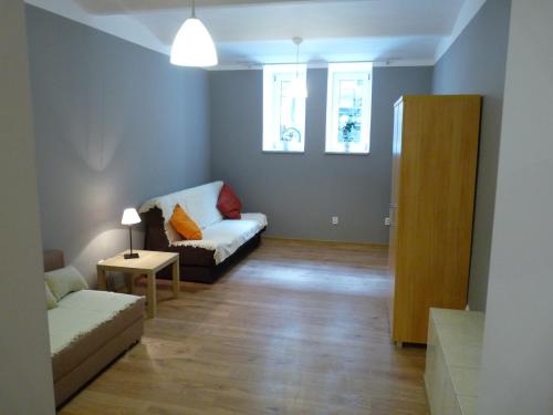 a living room with a couch and a table at Pokoje Gościnne Centrum in Krakow