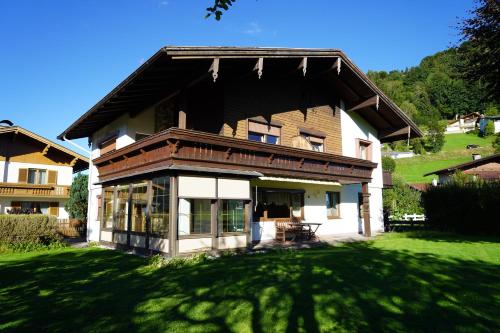 a large house with a green lawn in front of it at Panorama Appartements in Itter