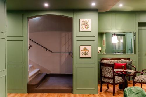 a room with green walls and a door with a staircase at Hotel Vier Jahreszeiten Salzburg in Salzburg