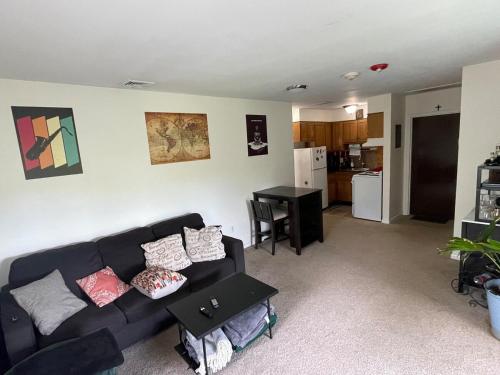 a living room with a couch and a table at Cozy One-Bedroom Retreat in the Heart of Smithtown in Smithtown
