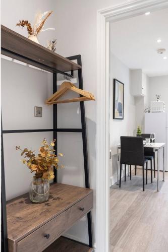 a room with a table with a vase of flowers at Perfect Flat Next To Highgate Station in London