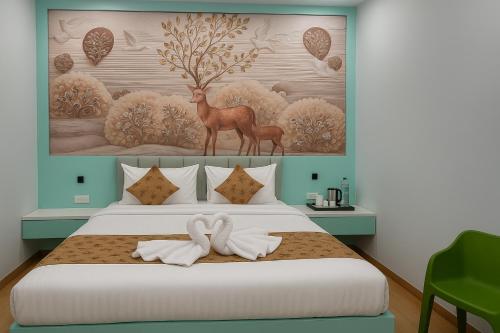 a bedroom with a bed with a deer and a painting at Siya Resort Ayodhya - Comfortable Rooms & Luxury Stay Near Ram Mandir in Ayodhya