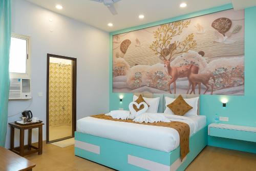 a bedroom with a bed with a painting on the wall at Siya Resort Ayodhya - Comfortable Rooms & Luxury Stay Near Ram Mandir in Ayodhya