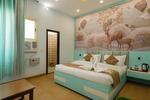 a bedroom with a bed with a painting on the wall at Siya Resort Ayodhya - Comfortable Rooms & Luxury Stay Near Ram Mandir in Ayodhya