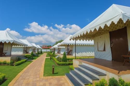 a row of white tents in a courtyard at Siya Resort Ayodhya - Comfortable Rooms & Luxury Stay Near Ram Mandir in Ayodhya