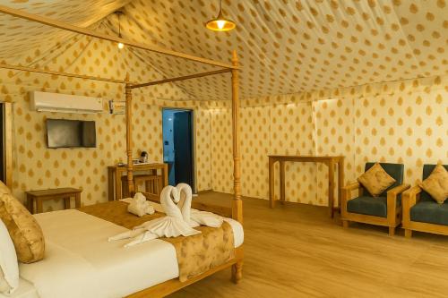 a bedroom with a bed with white towels on it at Siya Resort Ayodhya - Comfortable Rooms & Luxury Stay Near Ram Mandir in Ayodhya