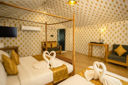 a bedroom with two beds with white towels at Siya Resort Ayodhya - Comfortable Rooms & Luxury Stay Near Ram Mandir in Ayodhya