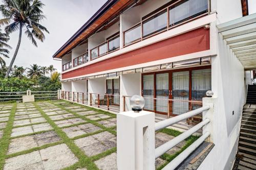 an exterior view of a house with a palm tree at OAK Edassery's Sealine Villa Stay in Cochin