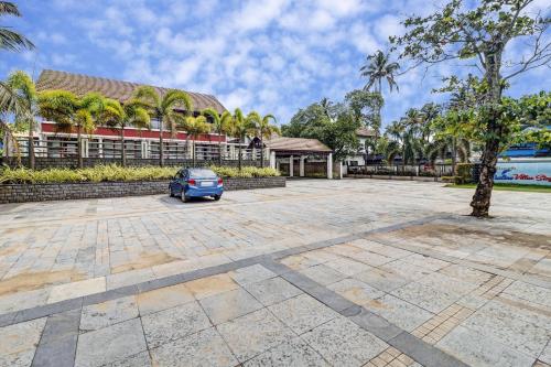 a car parked in a parking lot in front of a building at OAK Edassery's Sealine Villa Stay in Cochin
