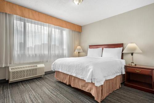 a hotel room with a bed and a window at Best Western Plus Suites Downtown Calgary in Calgary