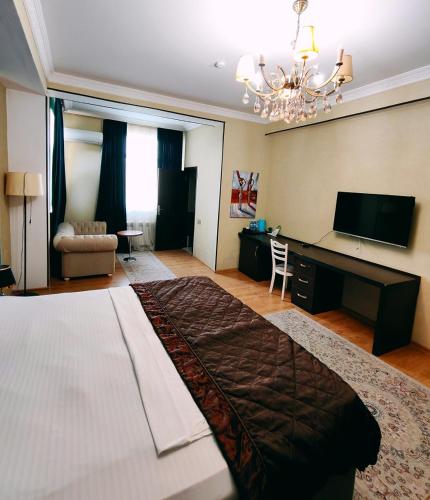 a large bedroom with a large bed and a desk at TWINS MIRROR group HOTELS in Baku