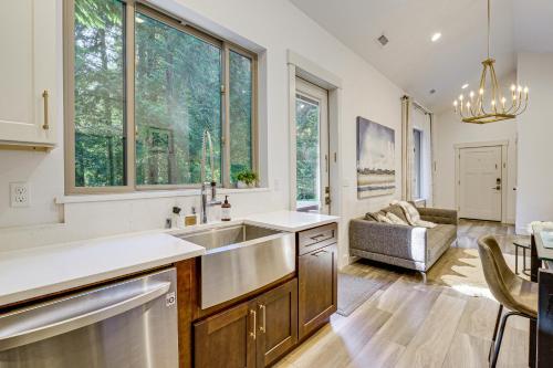 a kitchen with a sink and a living room at WFH-Friendly Gem with Creek 4 Mi to Sammamish Trail in Redmond