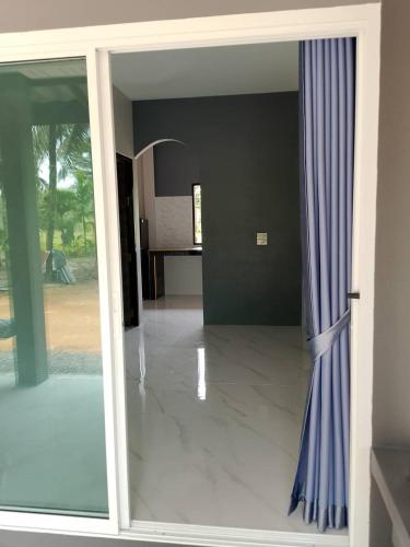 an open door to a living room with blue curtains at Dream House grop in Koh Samui