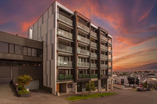 an rendering of an apartment building at sunset at Walk To Ponsonby and K Road Quiet Home with Blackout Blinds for the perfect sleep in Auckland