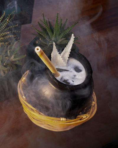 a drink in a bowl with a cigarette in it at Casa de la Luz Hotel Boutique in Mexico City