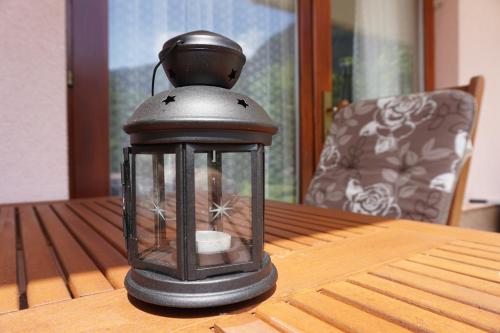 a lantern sitting on top of a wooden table at Apartments Kravanja in Bovec