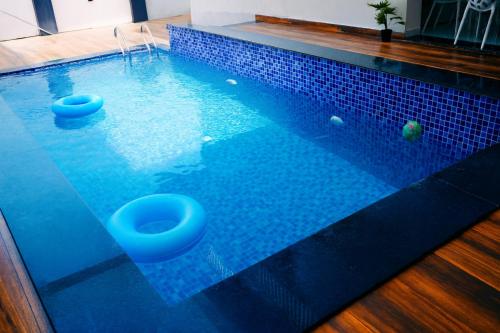 a swimming pool with two toilets in the water at EMPYREAN STAY II 6BHK II FLAGSHIP VILLA II AC II PVT POOL ll LAWN ll TERRACE in Lonavala