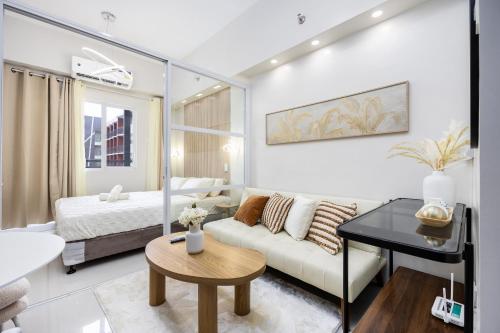 a living room with a couch and a bed at Cebu Serene Quarters with Pool View in Mactan Island