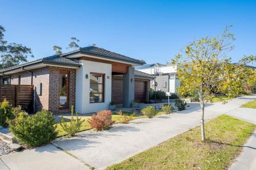 a house with a sidewalk in front of it at Cloverlea Spacious 4BR Yarra Valley Getaway in Lilydale