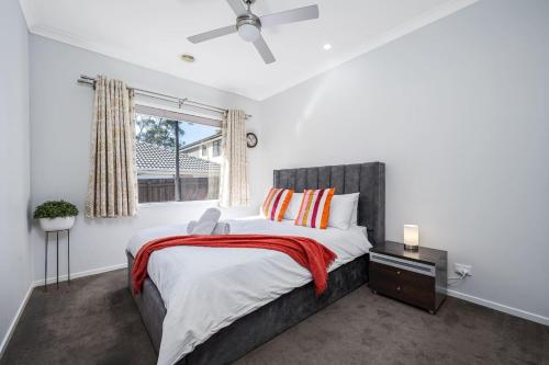 a bedroom with a large bed and a window at Cloverlea Spacious 4BR Yarra Valley Getaway in Lilydale
