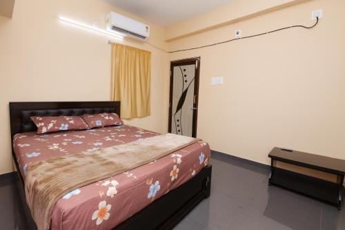 a bedroom with a bed and a air conditioner on the wall at Brand New Spacious and luxurious 2bhk Hill View Apartment in Tirupati close to railway station and bus stand - 201 in Tirupati
