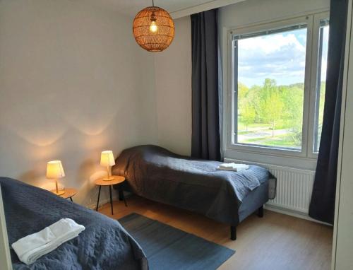 a bedroom with two beds and a window at Central and Spacious Apartment for 4 in Mäntsälä