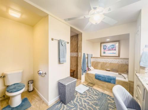 a bathroom with a tub and a toilet and a sink at Hook em on Paradise in La Grande Princesse