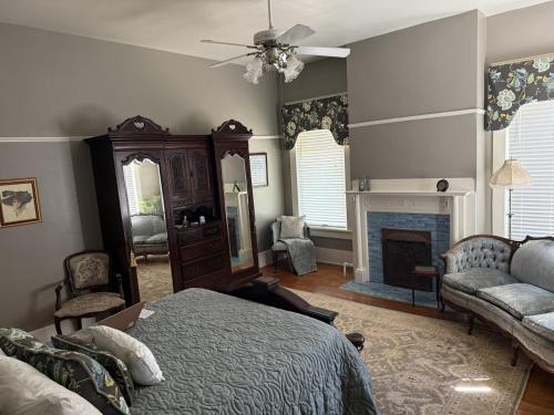 a bedroom with a bed and a fireplace at The Martha Dale at The Judges Chambers in Guthrie