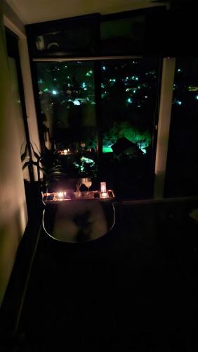 a window with a view of a city at night at Panoramic Box in Vişeu de Sus