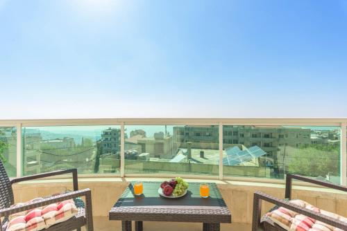 a table with a bowl of fruit on a balcony at Glint 3-Bedroom Apartment & Balcony in Aley in Aley