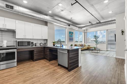 a large kitchen with white cabinets and a large island at City Vibes 2BR Walk Everywhere in DWNTN St. Pete in St. Petersburg