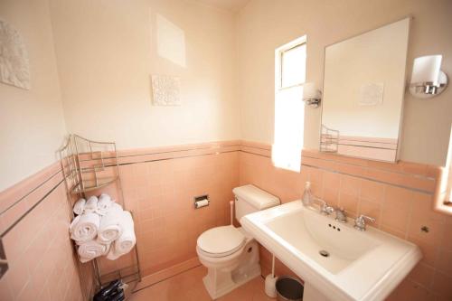 a bathroom with a white toilet and a sink at The Marlowe Family Suite in Santa Barbara
