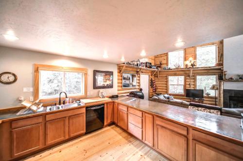 a kitchen with wooden cabinets and a counter top at Cascade Log Cabin by Casago McCall - Donerightmanagement in Cascade