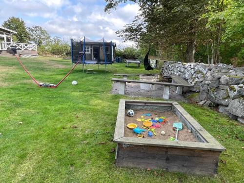 a play area with a table and a playground at 4 star holiday home in Drottningskär in Drottningskär