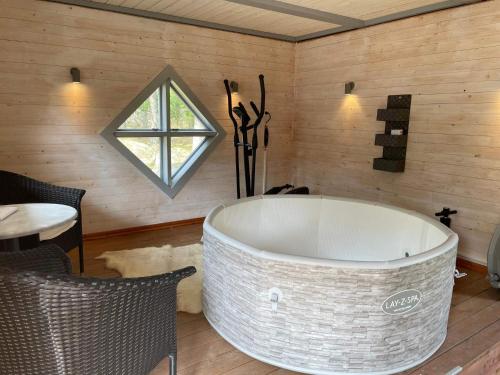a large white bath tub in a room with a window at 4 person holiday home in Drottningskär-By Traum in Drottningskär