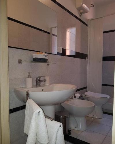 a bathroom with a sink and a toilet at Central Suites Catania in Catania