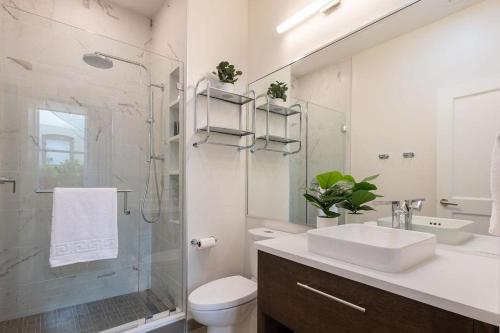 a bathroom with a sink and a toilet and a shower at Deja Blue in Baptist Hospital Heliport