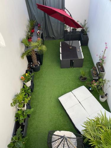 an overhead view of a patio with plants and an umbrella at Loft 11 personnes Sauna Jacuzzi in Mouscron