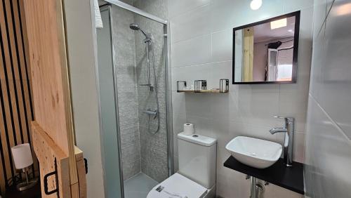 a bathroom with a shower and a toilet and a sink at CH Chelo in Madrid