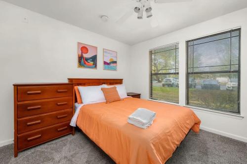 a bedroom with a bed and a dresser and a window at Spacious family home w patio in Tampa