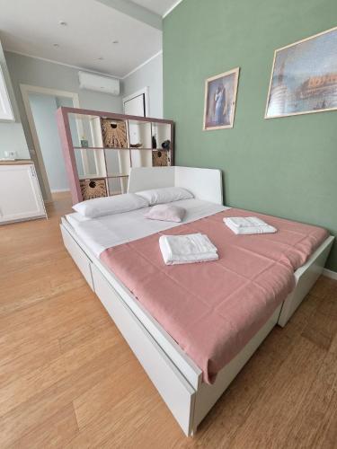a bedroom with a large bed with a red blanket at Il Fico d'India in Bresso