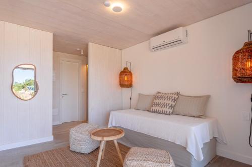 a bedroom with a bed and a table and a mirror at Anastasio Hotel & Beach Club in José Ignacio
