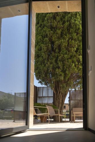 an open window with a view of a tree at Casale della Vittoria in Taranto