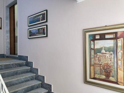 a painting on a wall next to a staircase at Boutique House in Benevento