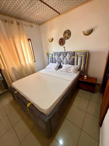 a large bed in a room with at LES LOGIS DE NOUVELLE ROUTE BASTOS in Yaoundé