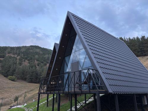 a house with a black roof on top of a hill at Space Trip Hotel in Artavaz