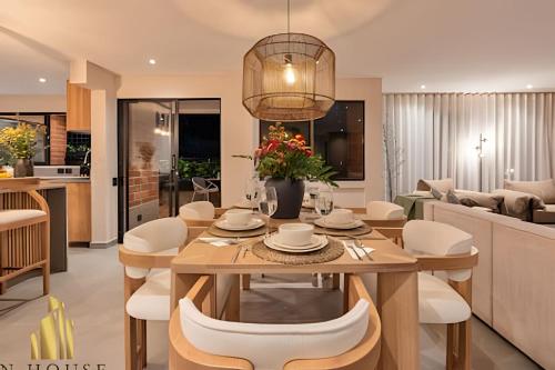 a dining room and living room with a table and chairs at Tivoli 202 - Escapada Premium con Jacuzzi Privado in El Poblado