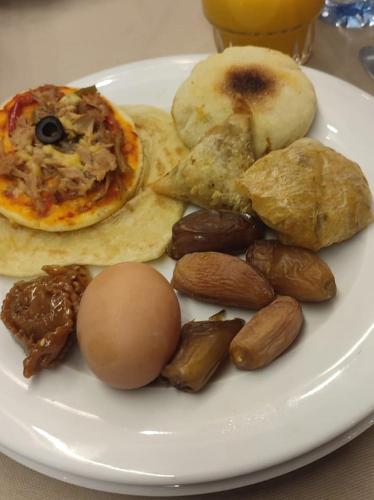 a plate of food with an assortment of foods at Desert Erg Camp Merzouga in Merzouga